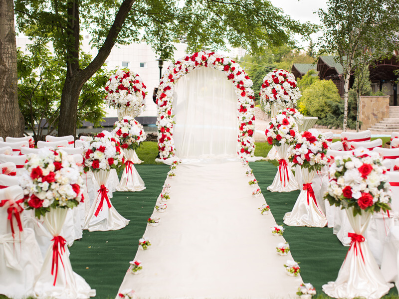 Lively Outdoor Wedding Décor With Aisle Runner, Fabric, Curtains, Arch Stand, Ribbons, & Florals 