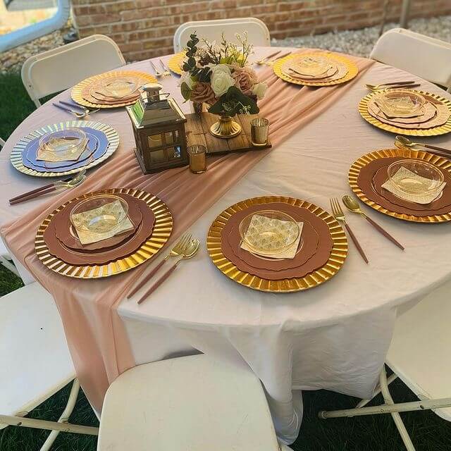 Striking Table Setup Using Tablecloth, Runner, Chargers, Cutlery, Lantern, Candle Holder & Floral