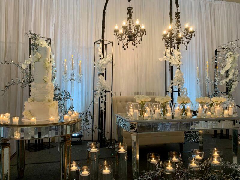 Posh Wedding Reception Decor With Glass Vases, Floating Candles, Votives, Metal Stands, and Flowers 