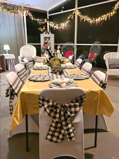 Beautiful Christmas Table Setup With String Lights, Table Linens, Chargers, Chair Covers, & Sashes