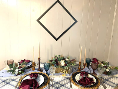 Sophisticated Table Setting With Runner, Candles, Flowers, Eucalyptus Stems, Napkins, & Rings