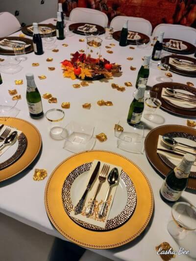 Fall Table Setting With Tablecloth, Chargers, Cutlery, Napkins, Petals, Vase, Cups, & Maple Leaves