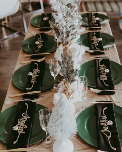 Chic Christmas Party Table Décor Featuring Tablecloth, Feathers, Plates, Glasses, Napkins, & Cutlery