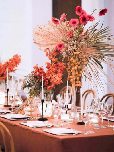 Stylish Table Setup Using Tablecloth, Chargers, Napkins, Candles, Vases, Flowers, & Cutlery