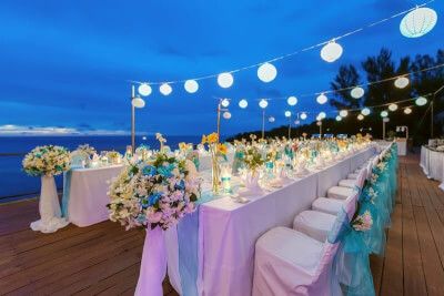 Scenic Outdoor Wedding Setting using Tablecloth, Chair Covers, Chair Sashes, Flower Bouquets