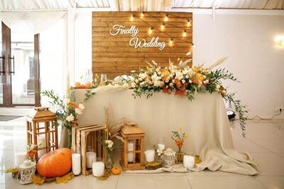 Rustic Wedding Setting Backdrop with Drape, Flowers, Leaves, Boxes