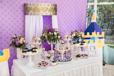 Grand Dessert Table Setup Using Tablecloths, Table Skirts, Cupcake Stands, Trays & Floral Decors