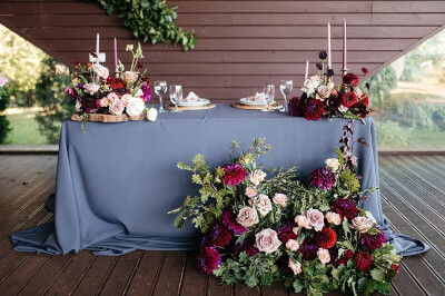 Sophisticated Table Setup Using Tablecloths, Floral Decors, Candles, & Disposable Dinnerware