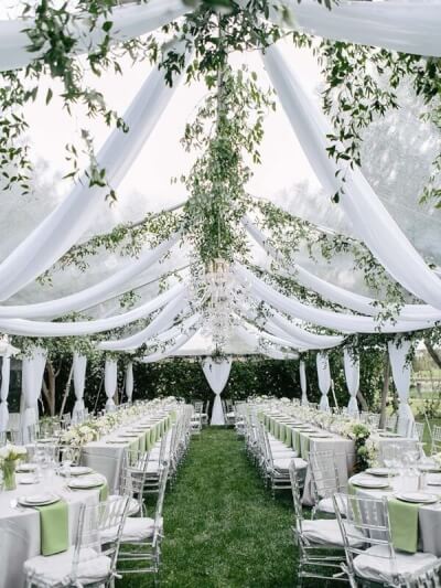 Captivating Outdoor Wedding Setting Using Drapes, Tablecloth, Table Napkins, Leaf Garlands & Flowers