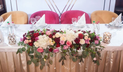 Candid Wedding Table Setup Using Table Skirt, Dinner Napkins, Flowers, Beaded-Curtains & Candles