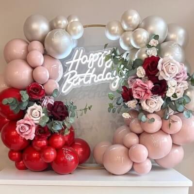 Delightful Birthday Balloon Décor With Metal Hoop, Neon Sign Lights, Flowers, Foliage, & Balloons