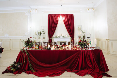 Bold Wedding Table Setup Using Tablecloth, Curtain, Flowers, Leaves & Candles