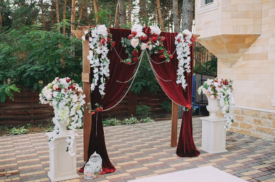 Attractive Backdrop Decor With Curtains, Beaded Chains, Column Stands, Pots, Bird Cages, & Flowers