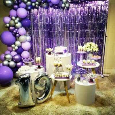 Flashy Birthday Decor With Foil Curtains, Number Balloons, Pillar Props, Flowers, & Balloon Garland