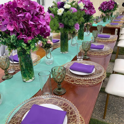 Fanciful Wedding Table Decor With Runner, Placemats, Napkins, Vases, Glasses, Greenery, & Flowers