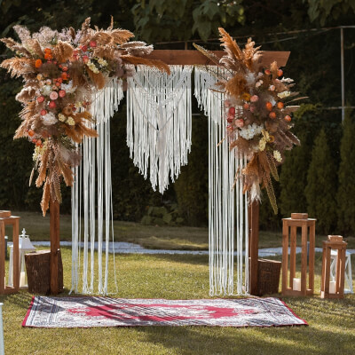 Enticing Boho Fall Wedding Decor With Backdrop Stand, Dry Grass, Flowers, Candles, & Lanterns