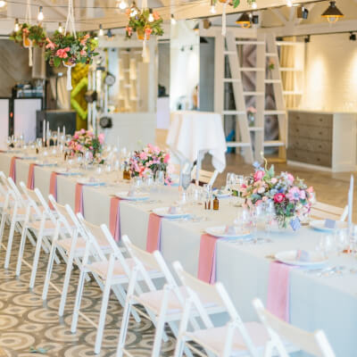 Indoor Wedding Decor With Tablecloth, Chair, Napkin, Macrame Pots, String Lights, Foliage, & Flowers