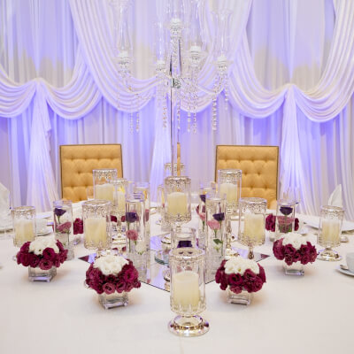 Elegant Wedding Decor With Drapes, Tablecloth, Mirror, Candle Stands, Napkins, Flowers, & Candelabra