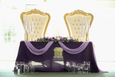 Luxurious Wedding Couple’s Table Using Tablecloth, Candles, Flowers, Garlands & Drapes