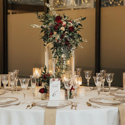 Alluring Table Décor Using Tablecloth, Napkins, Chargers, Flowers, Vase, Candles, & Candle Holders 