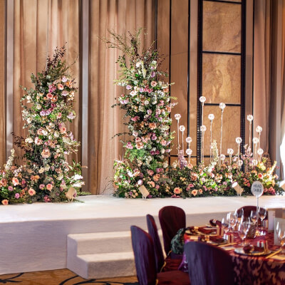 Chic Wedding Setup Using Drapes, Flowers, Backdrop Stand, Tablecloths, Napkins, & Glasses