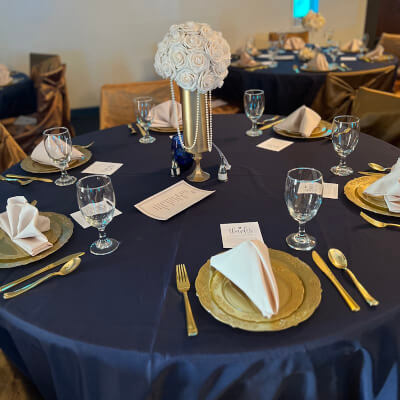 Elegant Table Decor Using Tablecloth, Flowers, Vase, Chargers, Napkins, Glasses, & Chair Covers