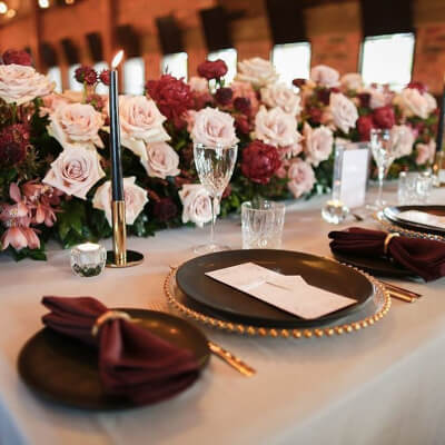 Mesmerizing Table Décor Using Tablecloth, Flowers, Chargers, Napkins, Candles, & Glasses