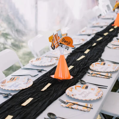 Mesmerizing Party Table Décor Featuring Table Runner, Paper Plates, Cutlery, & Chairs 