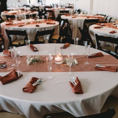 Alluring Table Décor With Table Covers, Runners, Napkins, Cutlery, Goblets, Candles, & Flowers