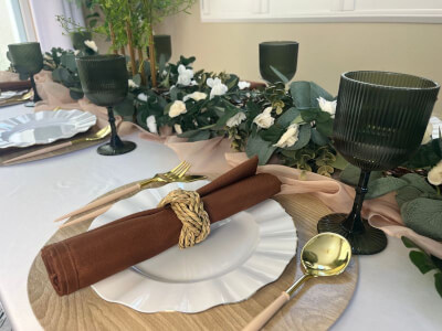 Boho-Inspired Place Setting With Greenery Garland, Earthy Tones & Rolled Napkin Detail
