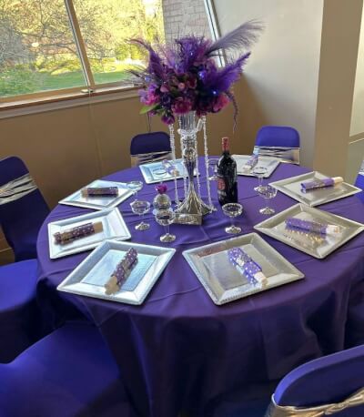 Luxurious Purple and Silver Table Setting with Feathered Floral Centerpieces and Silver Chargers