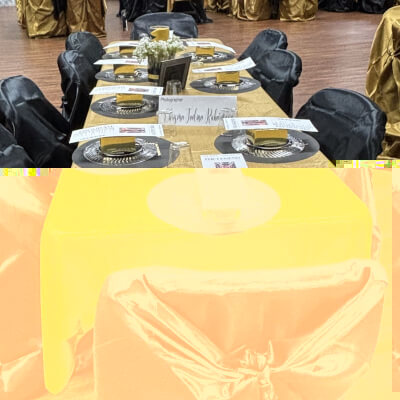 Glamorous Black and Gold Table Setting Featuring Universal Satin Chair Covers and Sleek Dinnerware