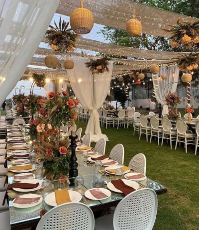 Boho-Rustic Garden Dining with Draped Canopy, Fall Florals, and Autumn-Colored Napkins