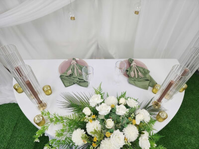 Fresh Garden-Inspired Tablescape with White Linens, Floral Centerpiece, and Candle Accents