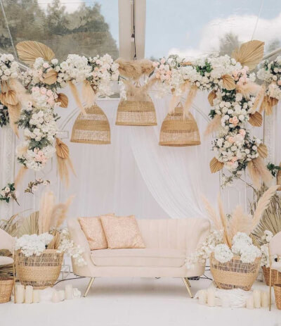 Romantic Lounge Styling with Pampas Florals, Draped Backdrop, and Rattan Décor
