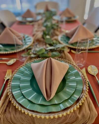 Natural Charm with Layered Plates, Neutral Napkins, and Rustic Cheesecloth Runner