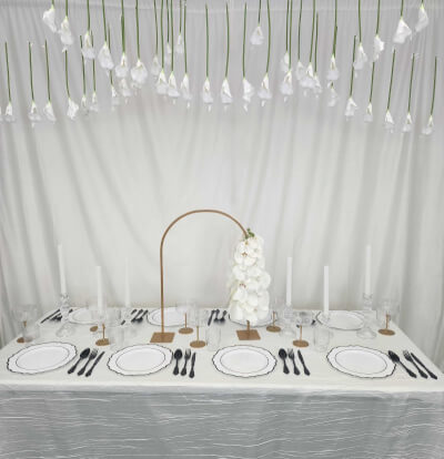 Timeless Luxury with Golden Arch, Floating Florals, Scalloped Dinnerware, and Black Accents