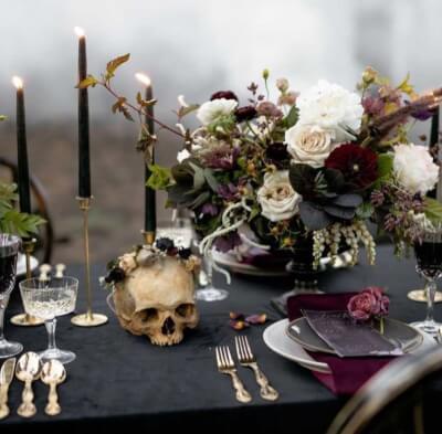 Romance Meets Gothic with Moody Blooms, Black Candles, Layered Plates and Skull Décor