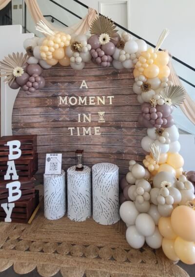 Earthy Rustic-Themed Baby Shower with Neutral Balloons, Wooden Backdrop, and Boho Accents