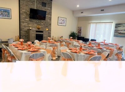 Radiance in Peach with Satin Chair Sashes, White Covers, and Tables Accented by Floral Touches