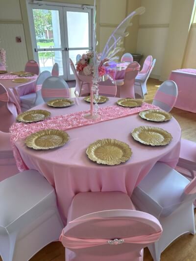 Whimsical Fairy-Themed Setup with Pink Covers, Rosette Runners, and Gold Leaf Chargers