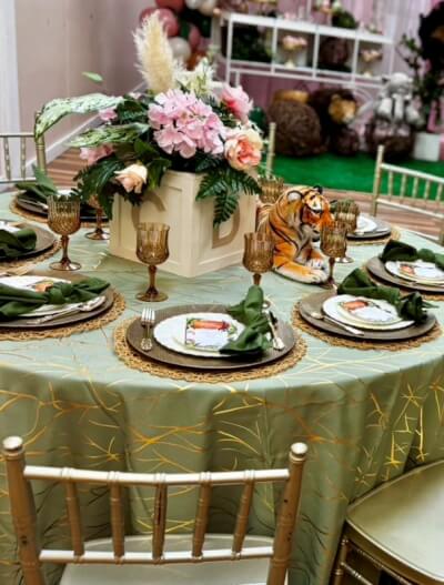 Blooming Elegance in Green and Gold with Geometric Linens, Layered Plates, and Floral Centerpiece