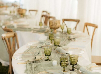 Earthy Chic Tablescape with Dusty Sage Cheesecloth Runner, Gold-Rimmed Plates, and Green Goblets