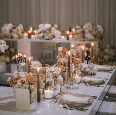 Dreamlike Reception Décor with Neutral Tones, Delicate Florals, Glass Accents, and Candlelit Ambianc