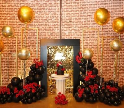 Celebrating in Style with Bold Black and Gold Balloons, Rose Accents and a Sequin Backdrop