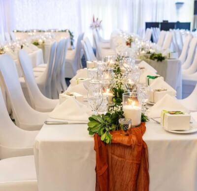 Chic All-White Reception with Earthy Accents, Glassware & Romantic Candle Glow
