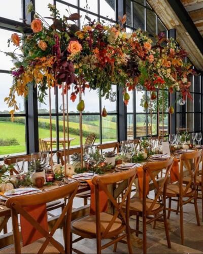 Rustic Harvest Tablescape in Fall-Inspired Hues with Overhead Florals & Sleek Dinnerware