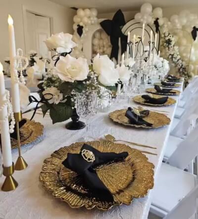 Monochromatic Tablescape with Gold Chargers, Black Napkins & White Rose Centerpieces