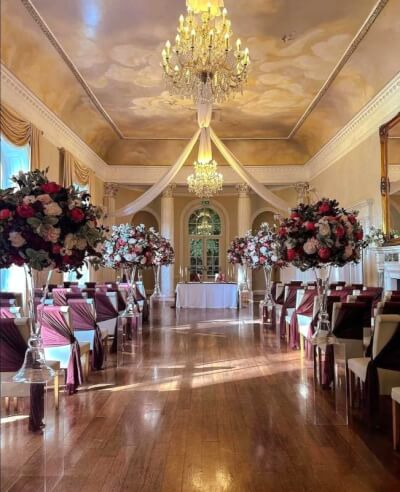 Celebrating Grandeur with Burgundy Aisle Florals, Chair Sashes & Draped Ceilings