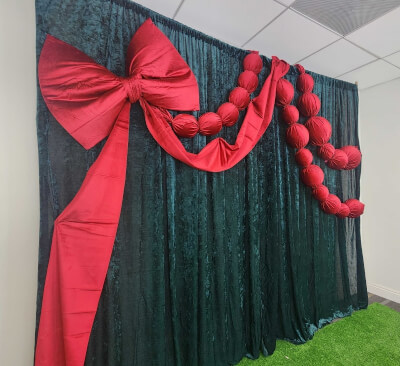 Dressed for the Holidays in Green Velvet Curtains and Bold Red Ribbon Accents